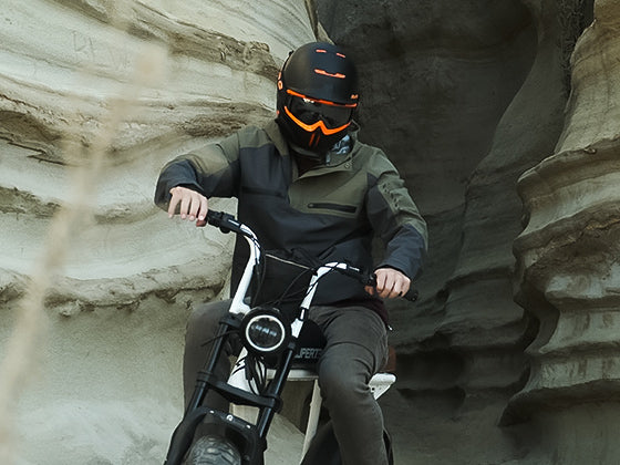 Rider on a Super73 ebike wearing a Field Research Division collection jacket