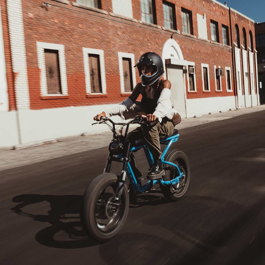 Blue Tang Super73 R Brooklyn ebike in front of brick warehouse