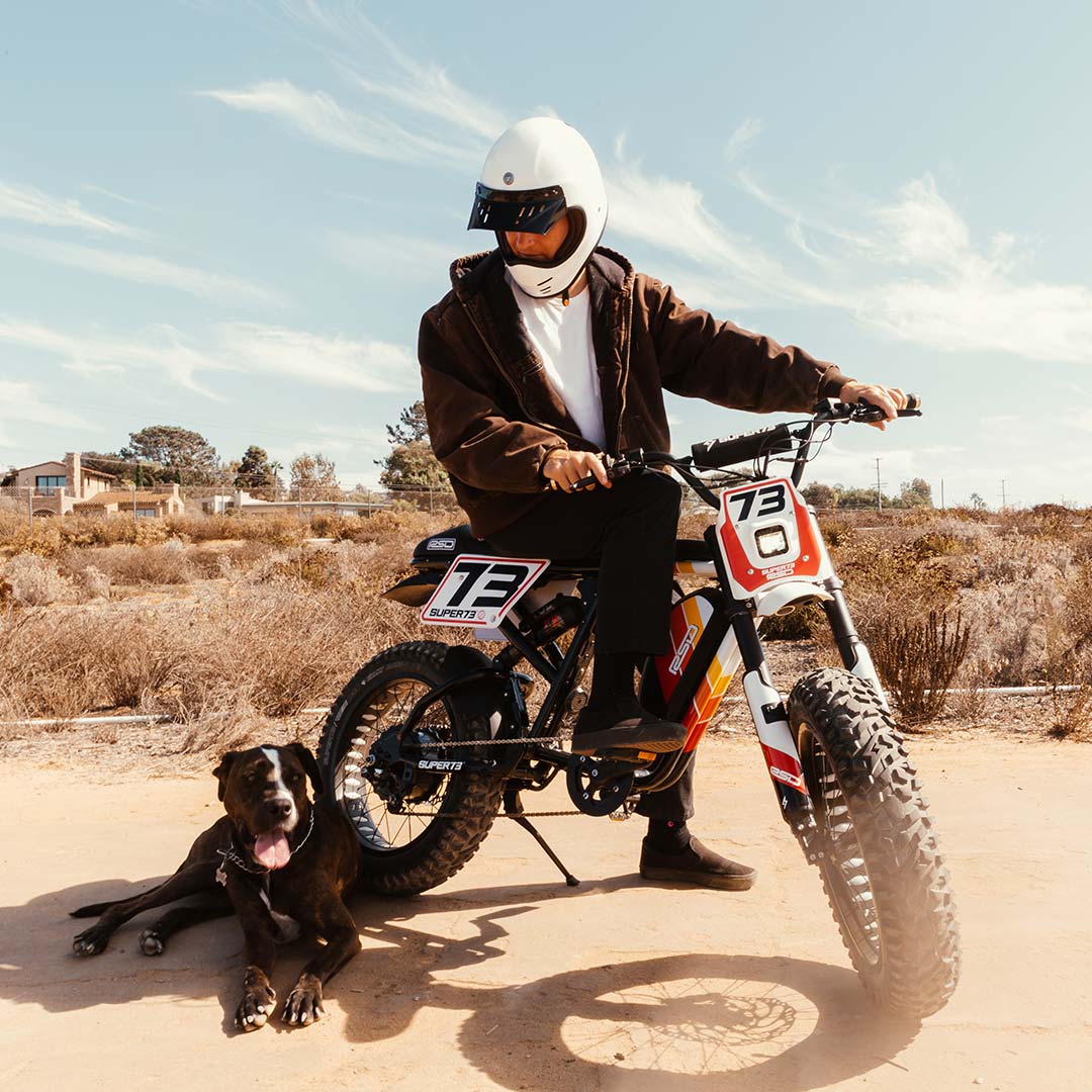Lifestyle image of RSD x SUPER73 RX Malibu with a rider and his dog