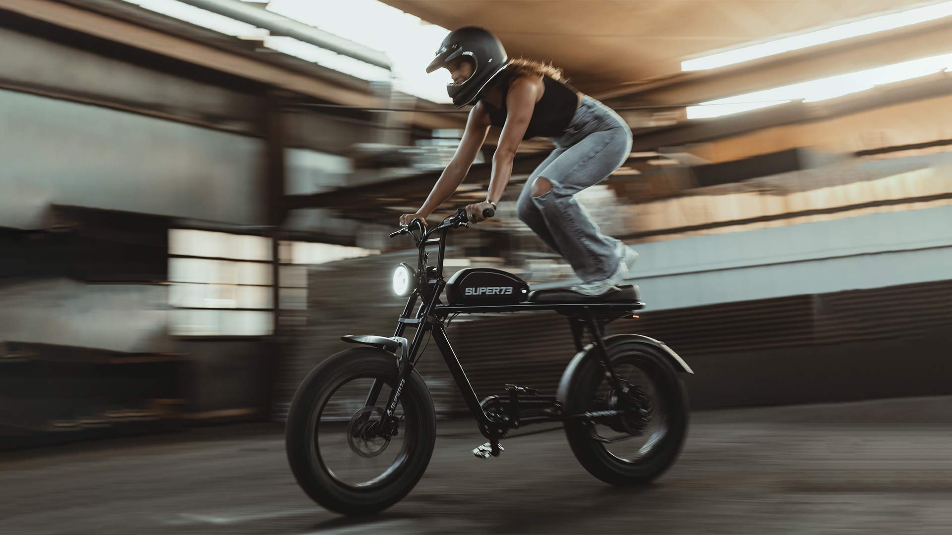 Super73 ebike stunt rider standing on seat