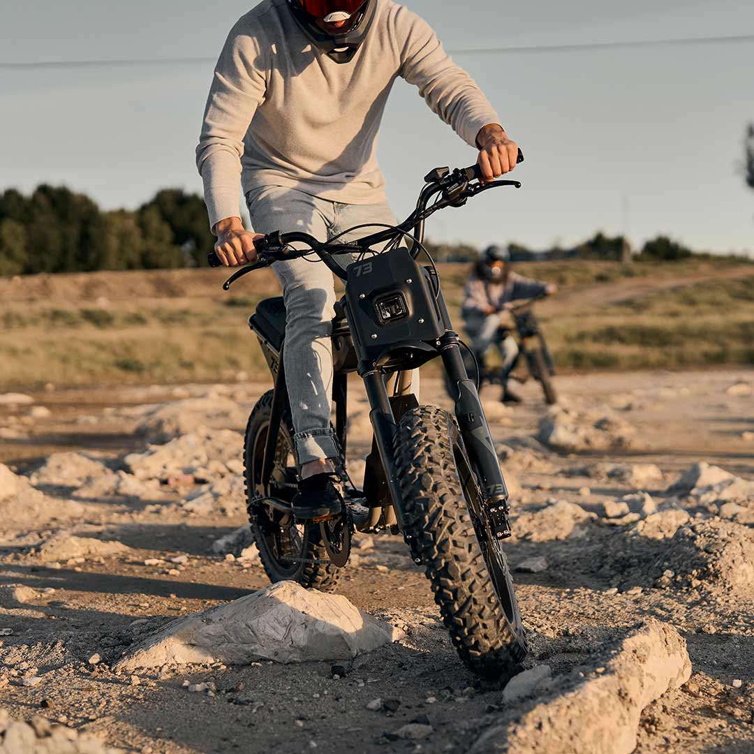 Male rider riding on his Z Adventure in the sun while wearing a helmet.