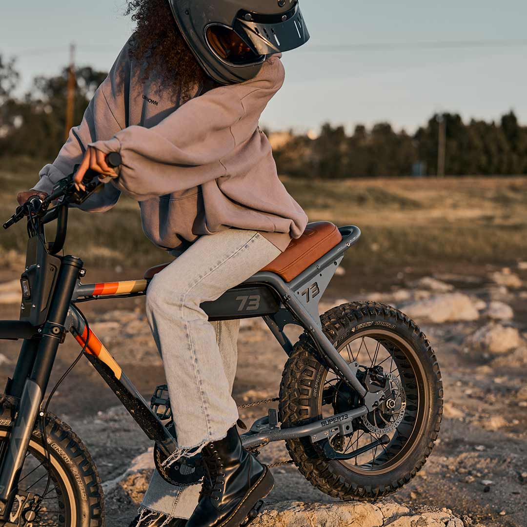 Female rider getting ready to rider her Z Adventure in the sun while wearing a helmet.