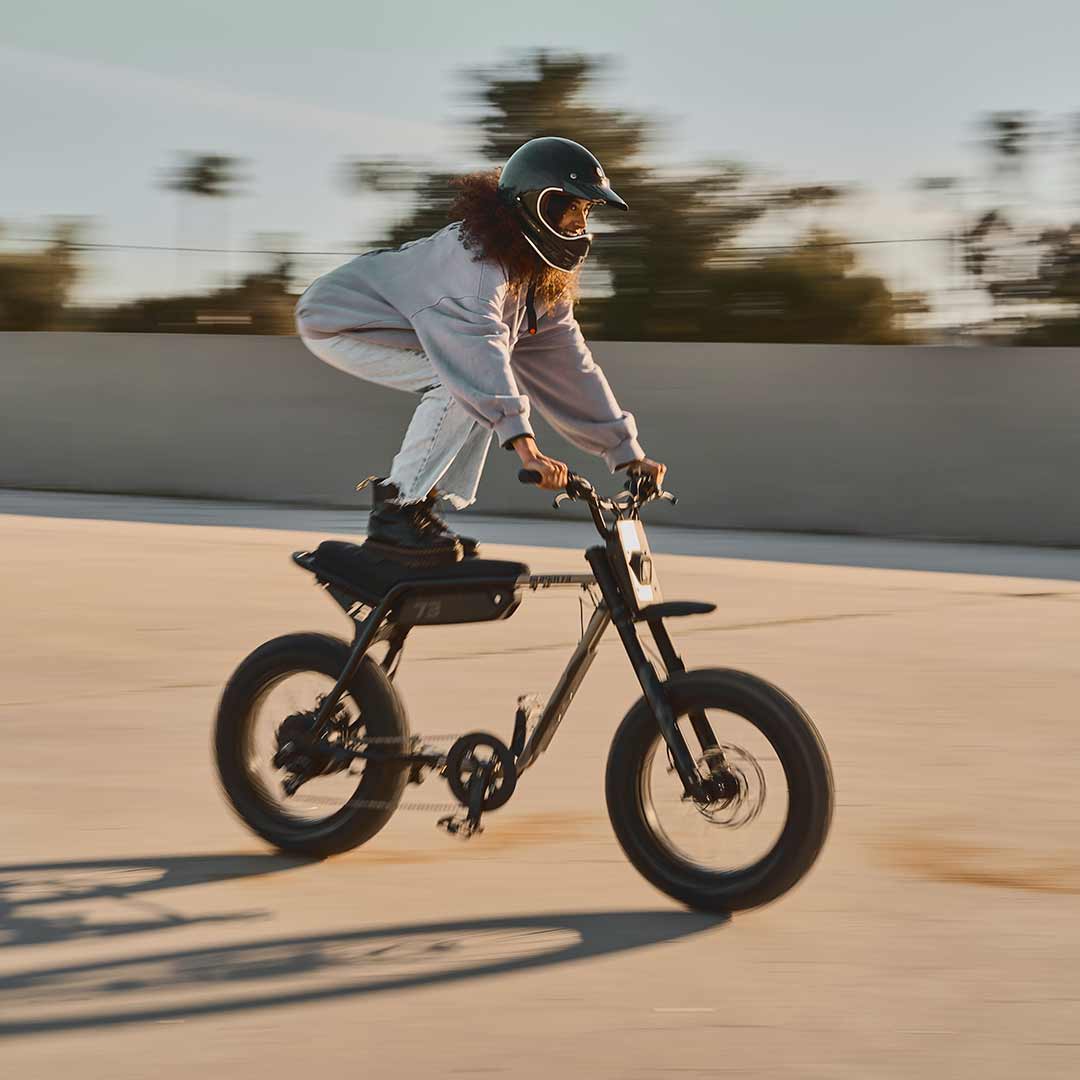 Female rider riding on her Z Adventure in the sun while wearing a helmet.