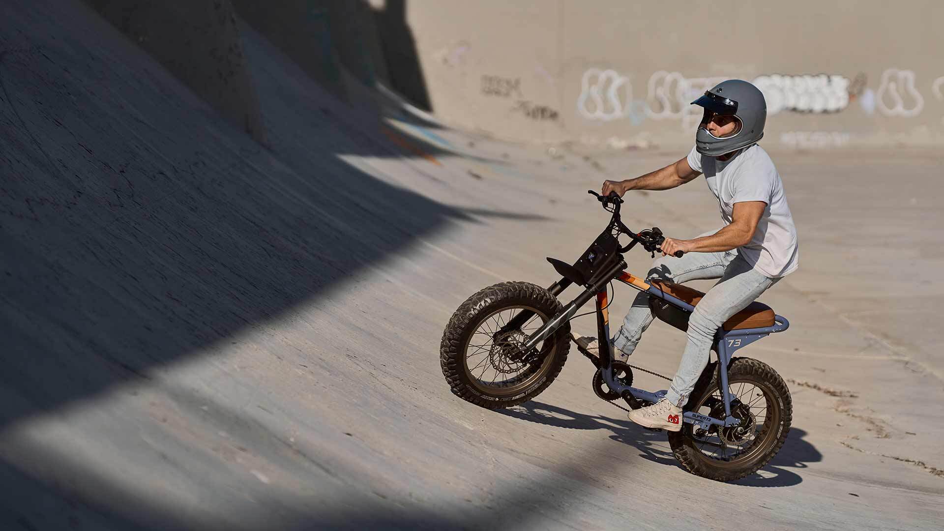 Rider on a Super73-Z Adventure ebike riding in a concrete alleyway