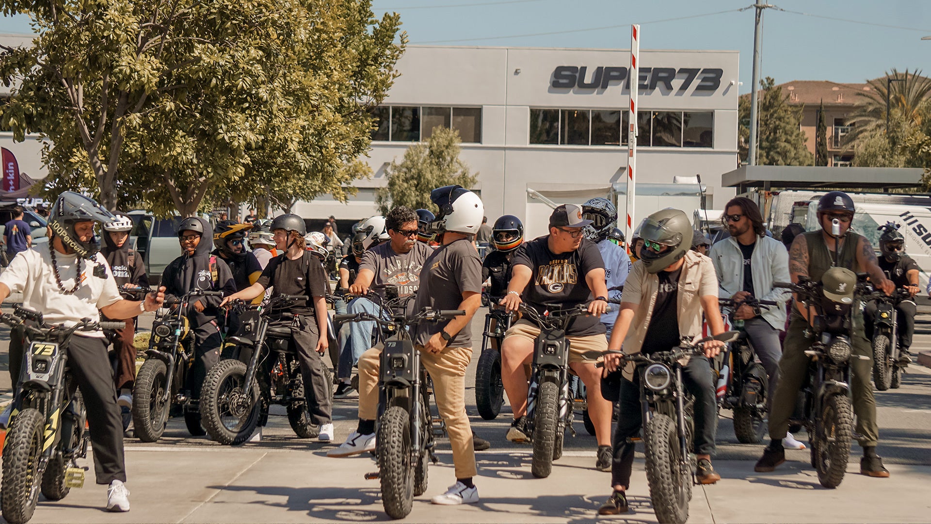 Photo of a group of riders gathered in front of the SUPER73 HQ