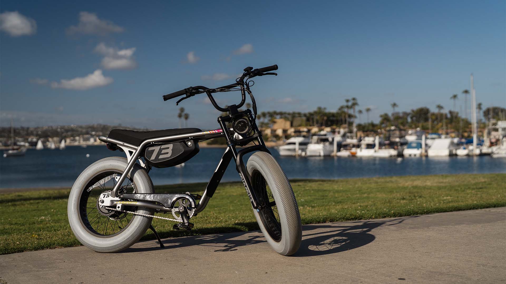 Lifestyle image of a SUPER73-Z Miami LE in ebike Speedway parked on a concrete path