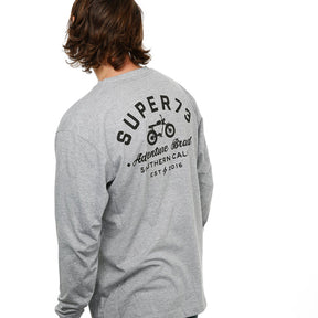 Side view of Male model in Heather Adventure Long Sleeve T-Shirt on white background.