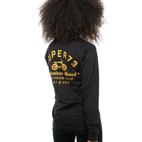 Side view of female model in Black Adventure Long Sleeve T-Shirt on white background.