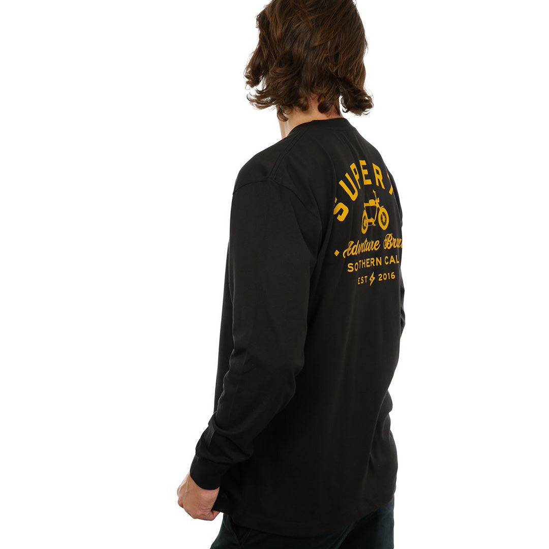 Side view of female model in Black Adventure Long Sleeve T-Shirt on white background.