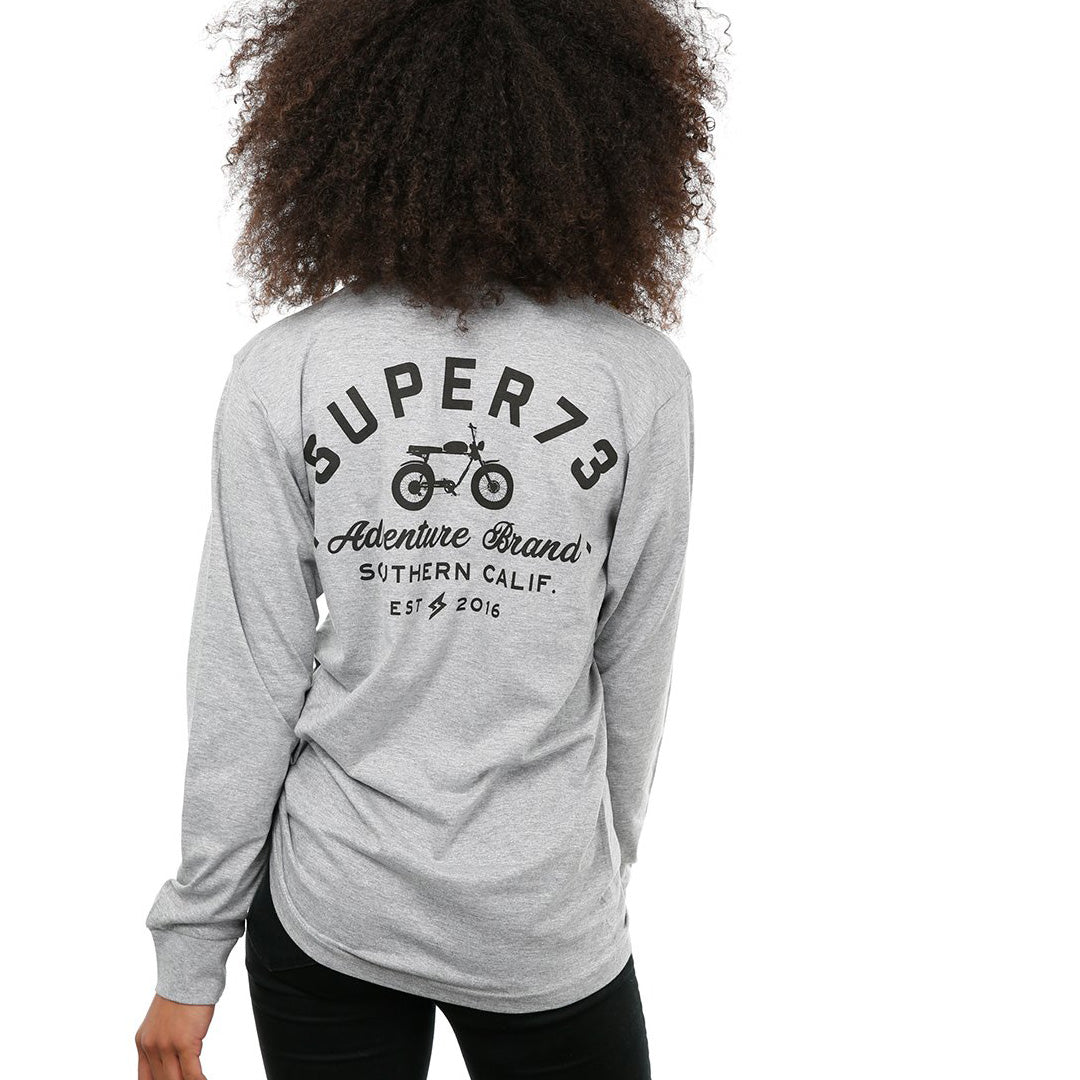 Back view of female model in Heather Adventure Long Sleeve T-Shirt on white background.