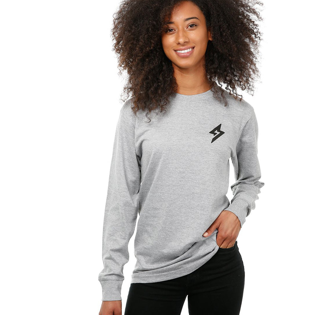 Front view of female model in Heather Adventure Long Sleeve T-Shirt on white background.