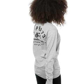 Side view of female model in Heather Adventure Long Sleeve T-Shirt on white background.