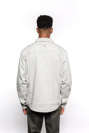 Back view of Male model wearing Anvil Chore Jacket in chalk colorway.