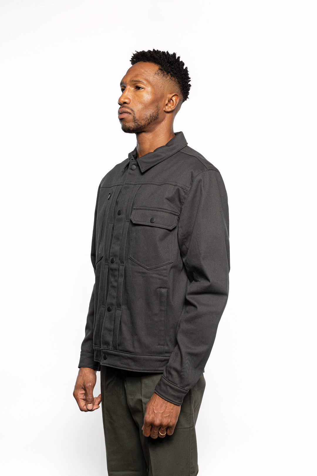 Side view of Male model wearing Anvil Chore Jacket in gravel colorway.