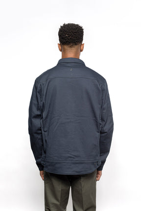 Back view of Male model wearing Anvil Chore Jacket in midnight colorway.