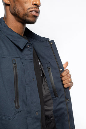 Male model showing inner details of Anvil Chore Jacket in midnight colorway.