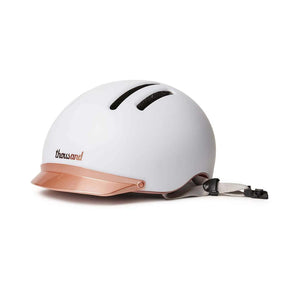 White Chapter MIPS Helmet by Thousand with rose gold visor on white background.