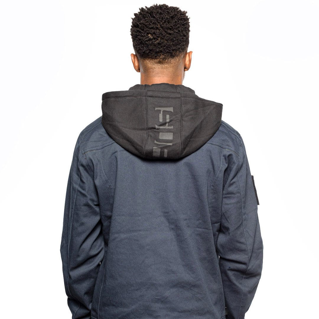 Back view of Male model wearing Chisel Hooded Jacket in midnight colorway.