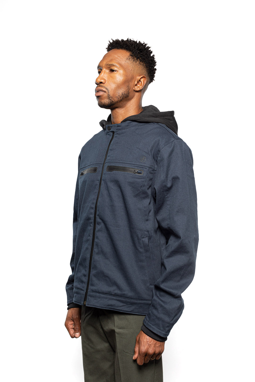 Side view of Male model wearing Chisel Hooded Jacket in midnight colorway.