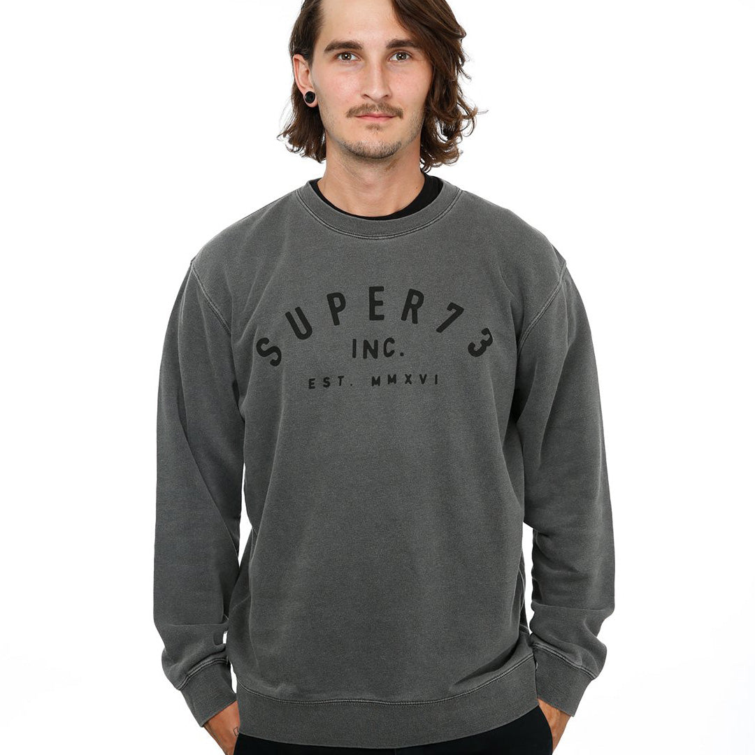 Front view of male model in Pigment Black Classic Crew Sweatshirt on white background.