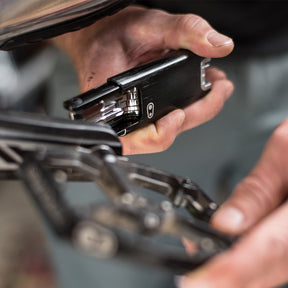 Crankbrothers F15 Multi-tool closeup being used on bike.