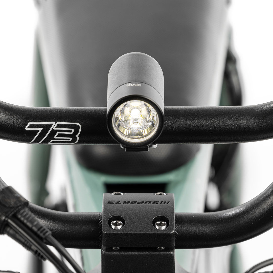 Plug front light mounted on handlebar with white background