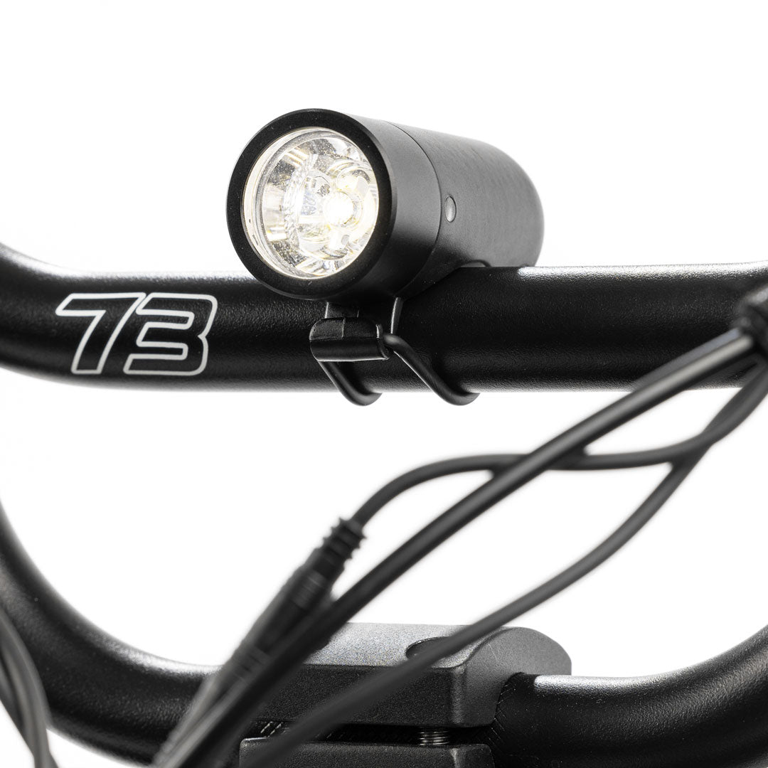 Plug front light mounted on handlebar with white background