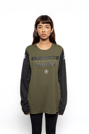 Female model front view of black and olive Premium long sleeve athletic moto hoon jersey.