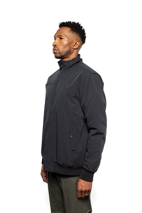 Side view of Male model wearing Royce Harrington Jacket in black colorway.