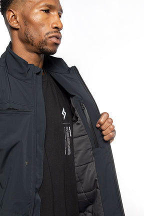Male model showing inner details of Royce Harrington Jacket in black colorway.