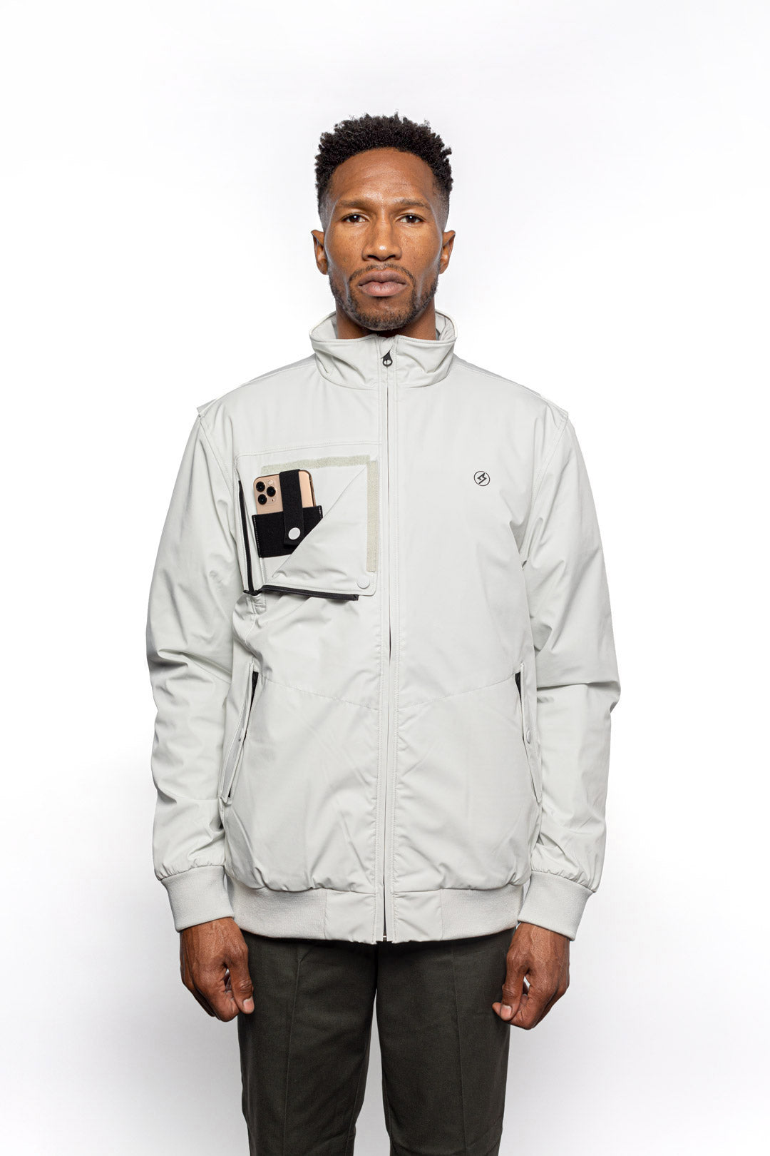 Front view of Male model wearing Royce Harrington Jacket in Chalk colorway showing pocket for iPhone.
